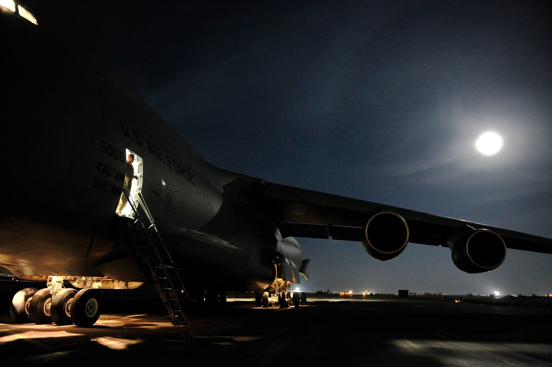 CAMP MARMAL, Afghanistan – U.S. Air Force Lt. Col. John Hardee, a C-5M Super Galaxy senior pilot assigned to the 436th Airlift Wing at Dover AFB, Del., looks out of crew entrance door after landing at here Jan. 28, 2013. The 621st sent a contingency response team to Mazar-e-sharif Afghanistan to provide en-route command and control and communications support in support of a U.S. transportation command intermodal movement of two U.S. Army Combat Aviation Brigades. (U.S. Air Force photo by Tech Sgt. Parker Gyokeres)