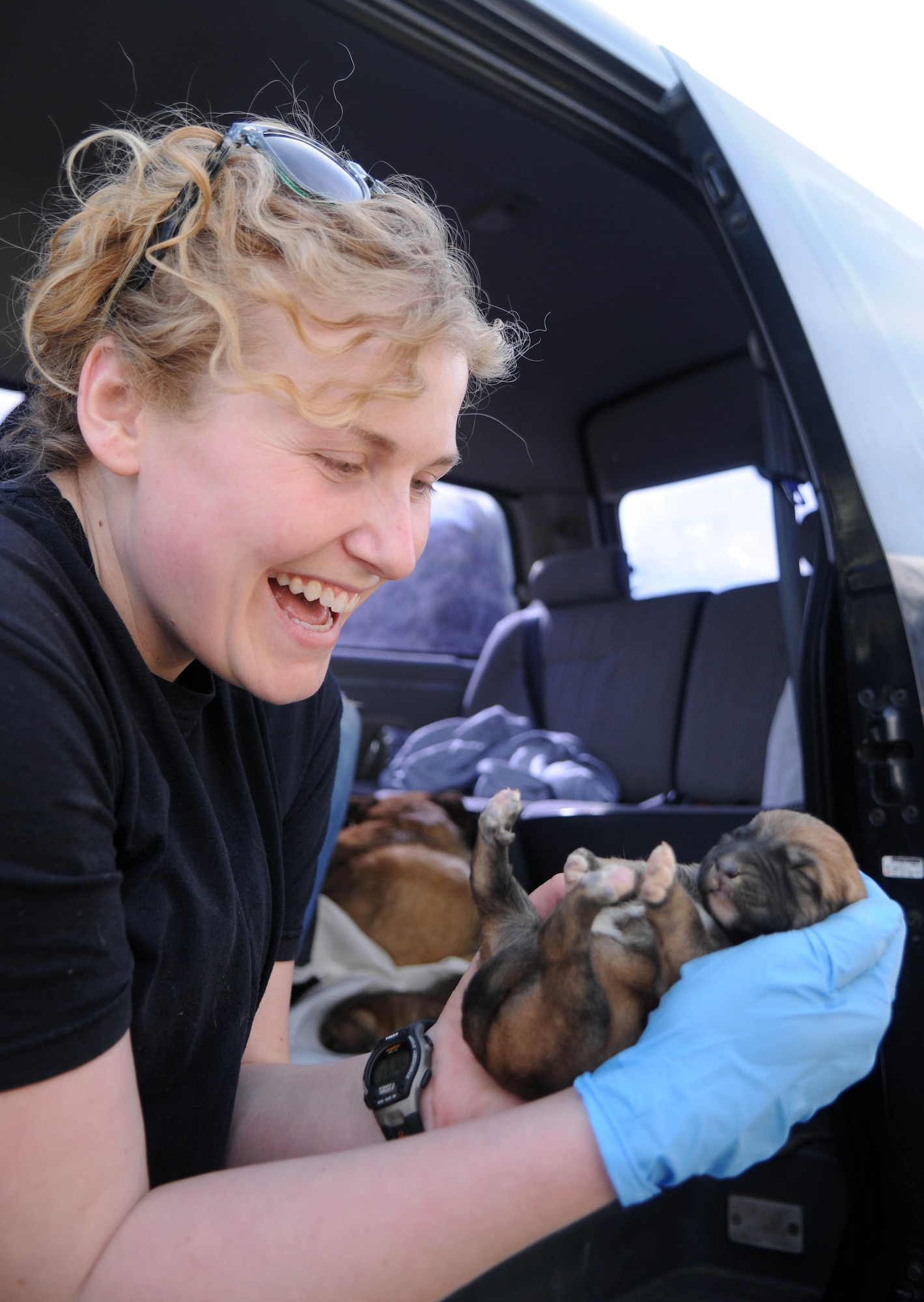 Tech. Sgt. Hannah Hobart, 100th Security Forces Squadron, plays with a newborn puppy at a shelter for strays in southwest Europe Feb. 10, 2013. Hobart, an Aurora, Ind., native, is part of a group of servicemembers deployed from RAF Mildenhall, England, in support of French operations in Mali, who volunteered to clean and play with the animals at the dog shelter during off-duty time. (U.S. Air Force photo by Staff Sgt. Austin M. May)