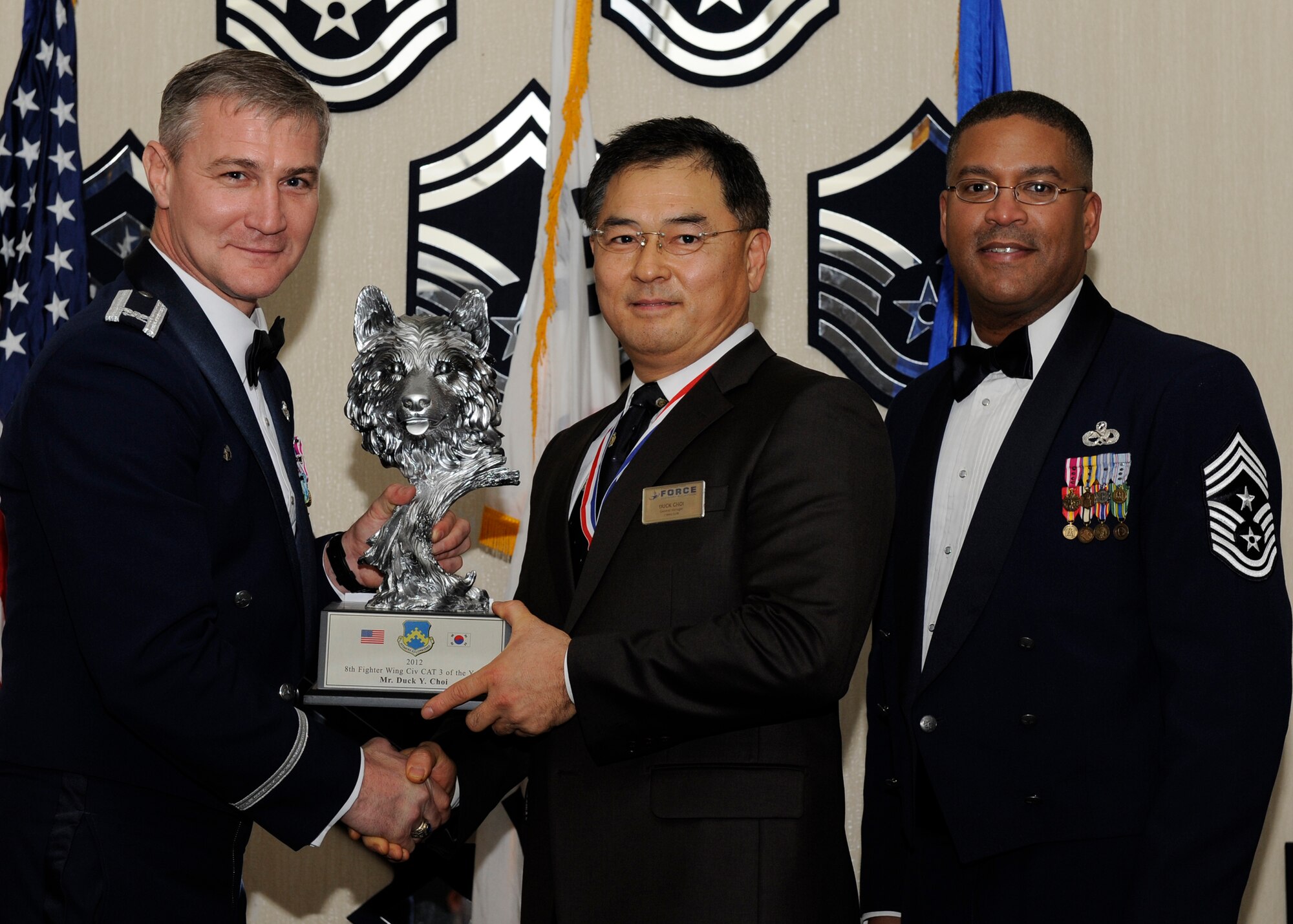Mr. Duck Y. Choi, 8th Force Support Squadron, receives the 8th Fighter Wing Civilian Category 3 of the Year award from Col. John Pearse, 8th FW commander, at Kunsan Air Base, Republic of Korea, Feb. 1, 2013. The award winners will continue on to compete in the 7th Air Force awards. (U.S. Air Force photo by Senior Airman Marcus Morris/Released)
