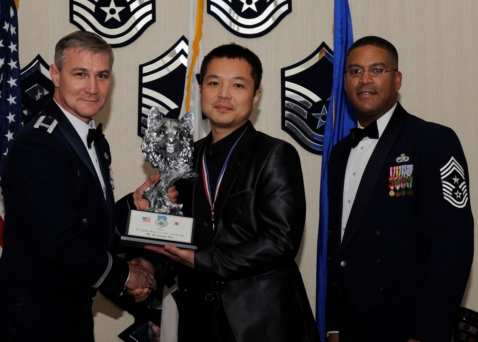 Mr. Ko Kwang Min, 8th Logistics Readiness Squadron, receives the 8th Fighter Wing Civilian Category 1 of the Year award from Col. John Pearse, 8th FW commander, at Kunsan Air Base, Republic of Korea, Feb. 1, 2013. The award winners will continue on to compete in the 7th Air Force awards. (U.S. Air Force photo by Senior Airman Marcus Morris/Released)