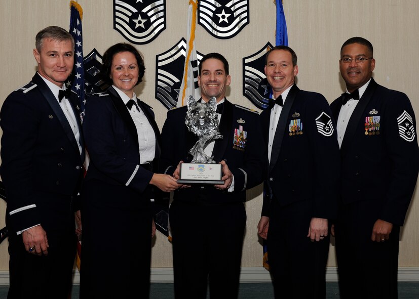 Members of the 8th Operations Support Flight, receive the 8th Fighter Wing Team of the Year award from Col. John Pearse, 8th FW commander, at Kunsan Air Base, Republic of Korea, Feb. 1, 2013. The award winners will continue on to compete in the 7th Air Force awards. (U.S. Air Force photo by Senior Airman Marcus Morris/Released)