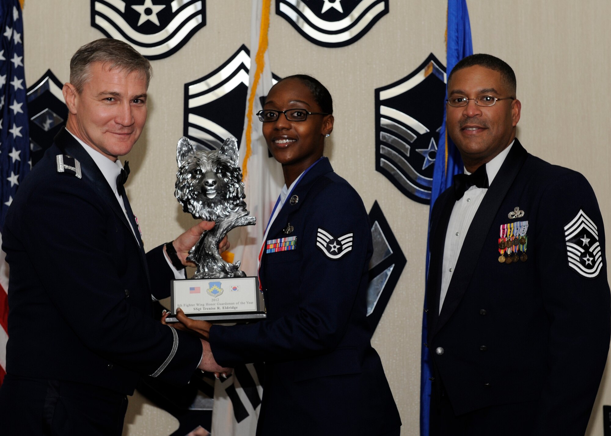 Staff Sgt. Trenise Eldridge, 8th Maintenance Operations Squadron, receives the 8th Fighter Wing Honor Guardsman of the Year award from Col. John Pearse, 8th FW commander, at Kunsan Air Base, Republic of Korea, Feb. 1, 2013. The award winners will continue on to compete in the 7th Air Force awards. (U.S. Air Force photo by Senior Airman Marcus Morris/Released)