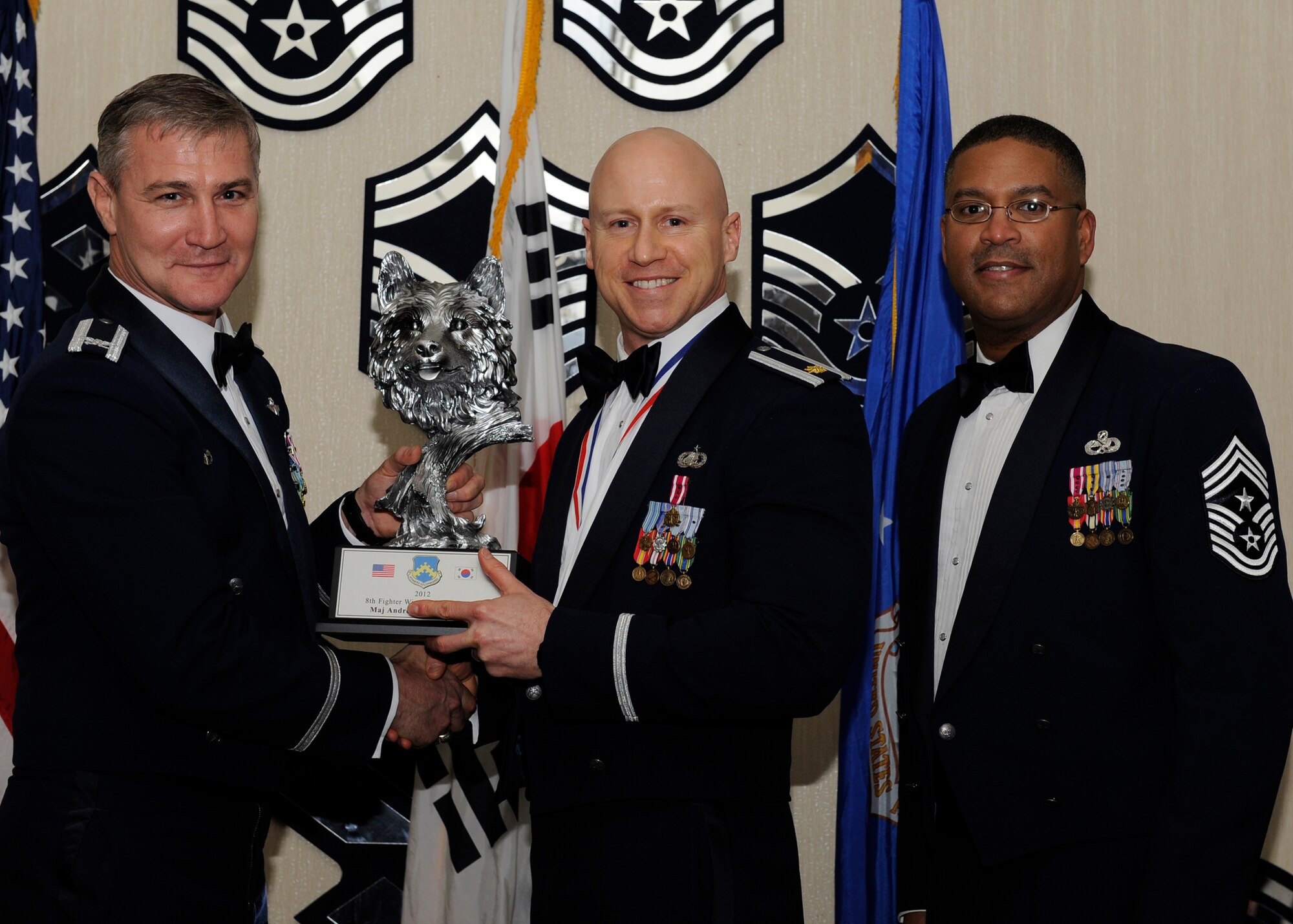 Major Andre Levesque, 8th Force Support Squadron, receives the 8th Fighter Wing Field Grade Officer of the Year award from Col. John Pearse, 8th FW commander, at Kunsan Air Base, Republic of Korea, Feb. 1, 2013. The award winners will continue on to compete in the 7th Air Force awards. (U.S. Air Force photo by Senior Airman Marcus Morris/Released)