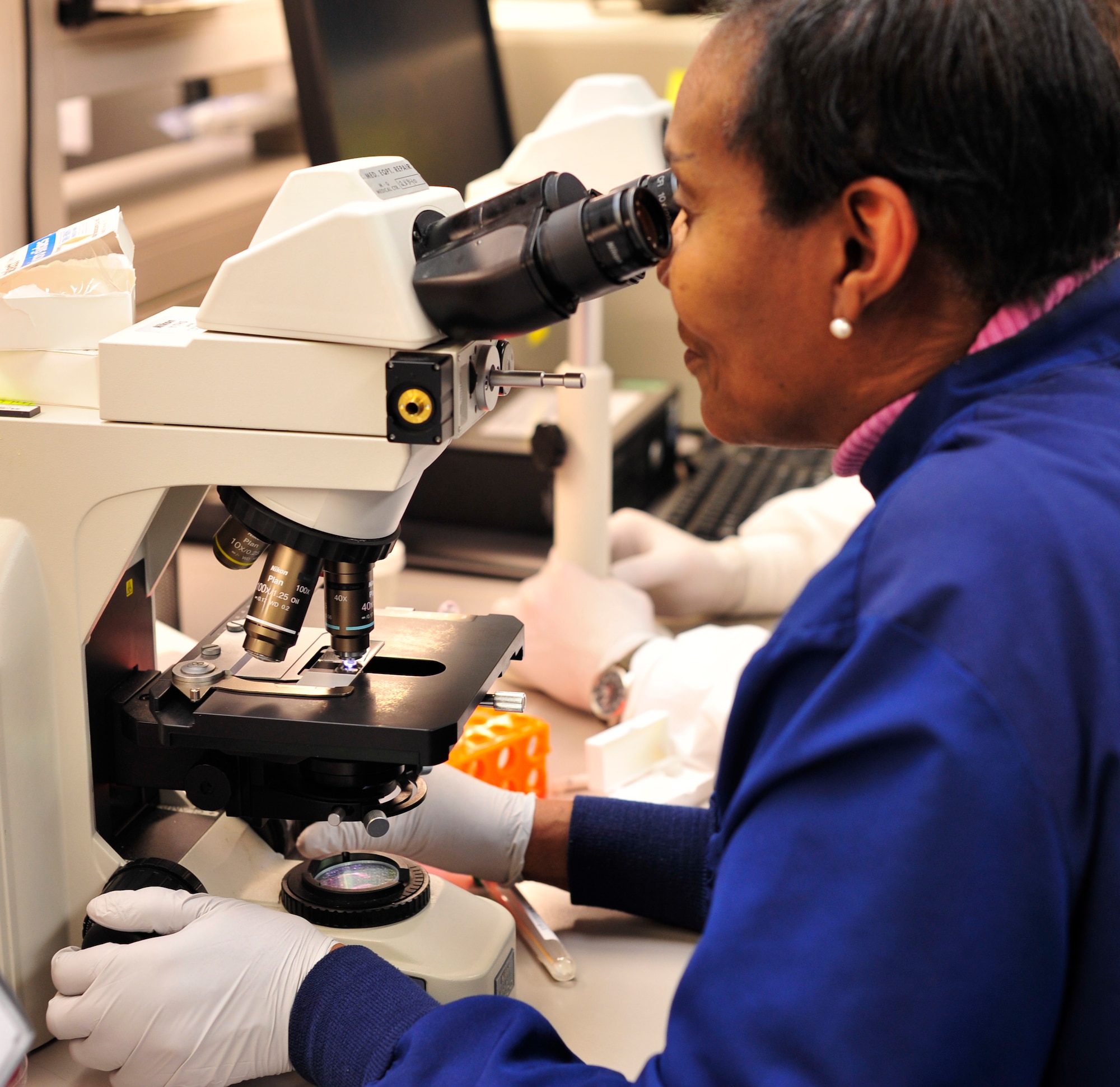 Mrs. Gloria Winston, 779th Medical Group medical laboratory technician, examines a wet prep slide Jan. 31, 2013 at Joint Base Andrews, Md.  The specimen is placed on a slide and then mixed with a salt solution so the infection can be identified and treated. (U.S. Air Force photo/ Airman 1st Class Erin O’Shea)   