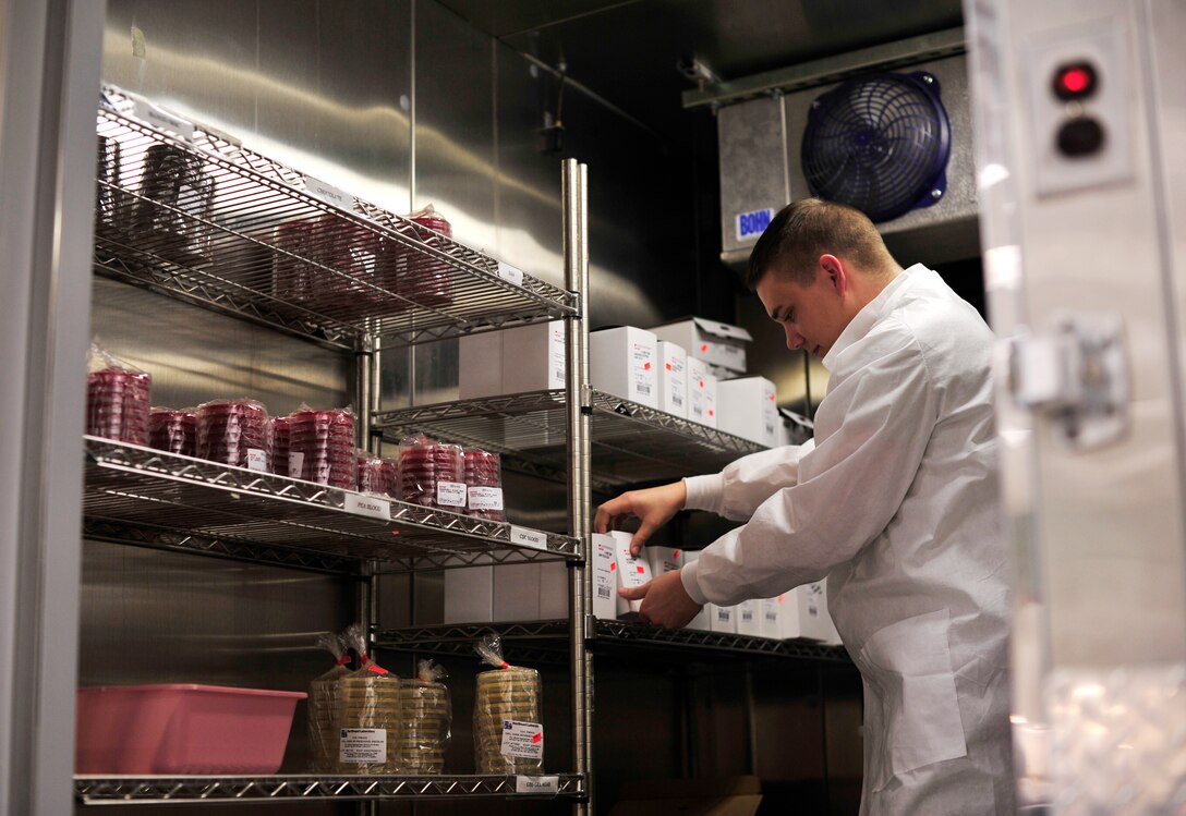 Senior Airman William Orren, 779th Medical Group medical laboratory technician, retrieves test kits from a microbiology refrigerator Jan.31, 2013 at Joint Base Andrews, Md. Cultures and tests are stored in the refrigerator on different racks to keep them sterile. (U.S. Air Force photo/ Airman 1st Class Erin O’Shea)         