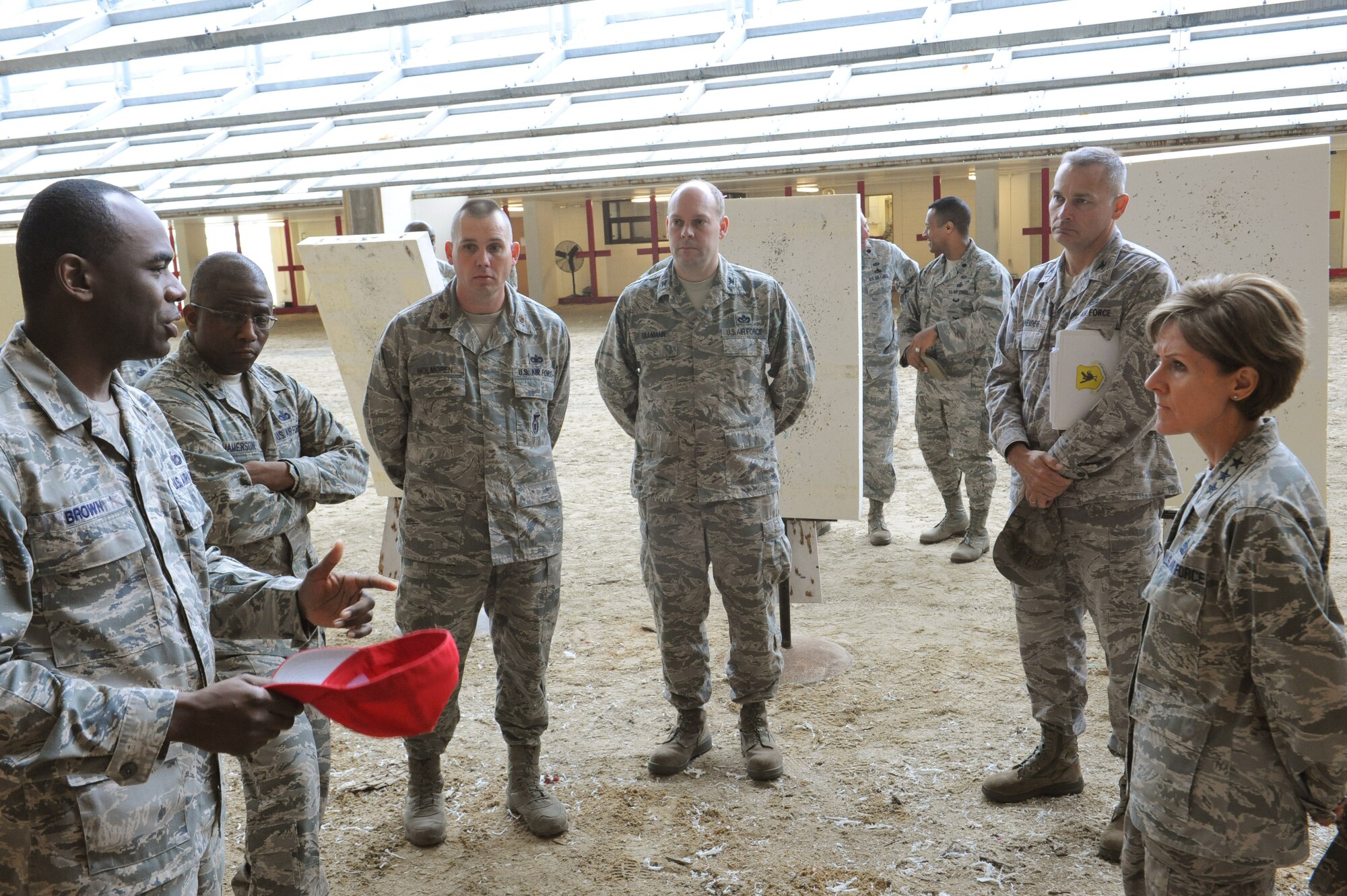 U.S. Air Force Tech. Sgt. Jahara Brown, 18th Security Forces Squadron NCO in charge of combat arms, briefs Lt. Gen. Judith Fedder, Deputy Chief of Staff for Logistics, Installations and Mission Support, Headquarters U.S. Air Force, Washington, D.C., on Kadena Air Base, Japan, Feb. 11, 2013. Brown explained some of the problems they have at the range and how their ventilation system works. (U.S. Air Force photo/Airman 1st Class Malia Jenkins)  