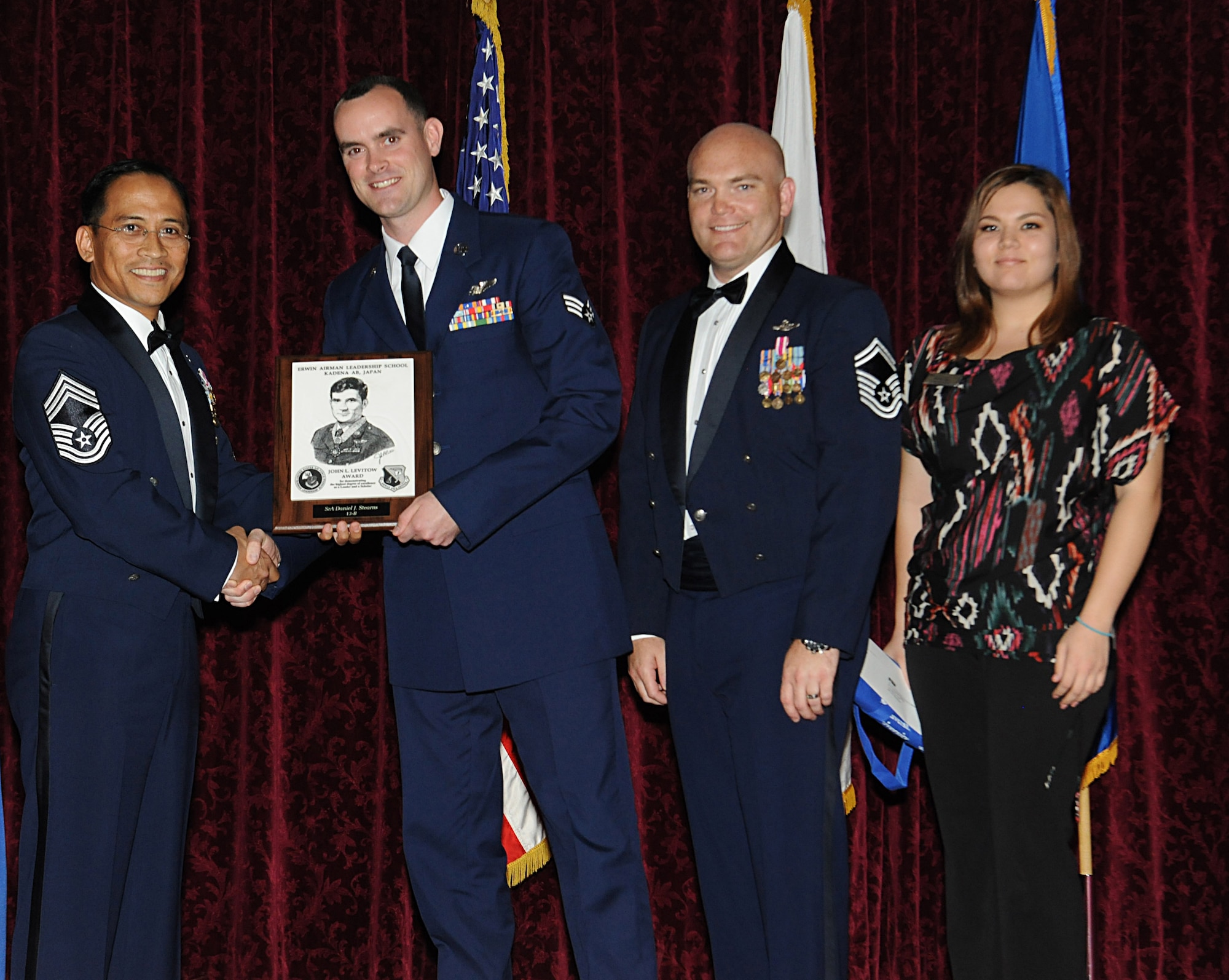 U.S. Air Force Senior Airmen Daniel Stearns, 1st Special Operations Squadron publications and standardization evaluation liaison officer/MC-130H Combat Talon II loadmaster, receives the John L. Levitow Honor Graduate award at the Airman Leadership School Class 13-B graduation ceremony at the Rocker NCO Club on Kadena Air Base, Japan, Feb. 11, 2013. This distinguished graduate award, sponsored by the Kadena Chiefs Group, is named in memory of Medal of Honor recipient Airman 1st Class John L. Levitow. The award is presented to the most outstanding member of each ALS class and denotes superior achievement as both a leader and scholar. (U.S. Air Force photo/Airman 1st Class Malia Jenkins)