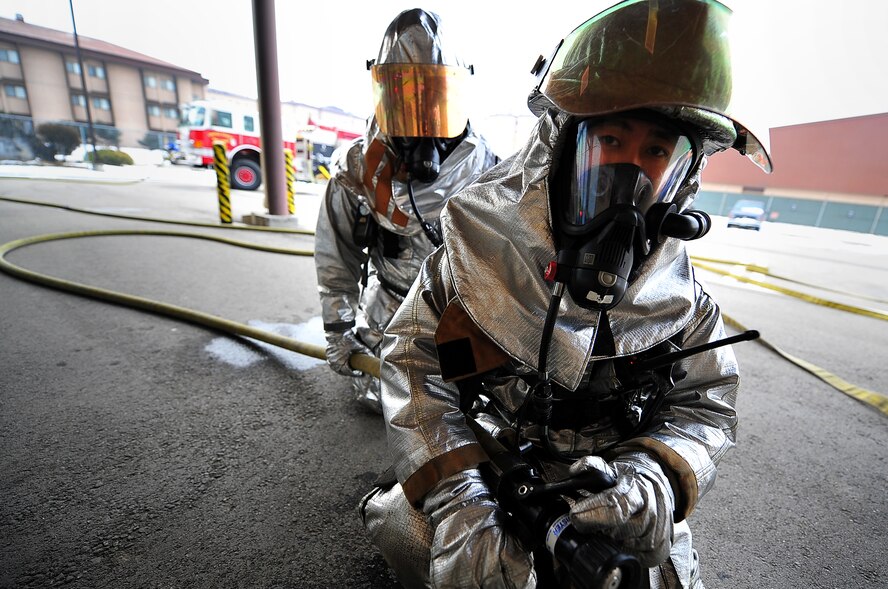 Senior Airman Juan Duarte, fire fighter with the 51st Civil Engineer Squadron, gets ready to enter a building with a simulated fire as part of a training scenario for an operational readiness exercise, Beverly Bulldog 13-02, at Osan Air Base, Republic of Korea, Feb. 12, 2013. These types of exercises help Airmen train in a heightened state of readiness in order to provide combat ready forces for close air support, air strike control, counter air, interdiction, theater airlift, and communications in the defense of the Republic of Korea. (U.S. Air Force photo/Staff Sgt. Sara Csurilla)