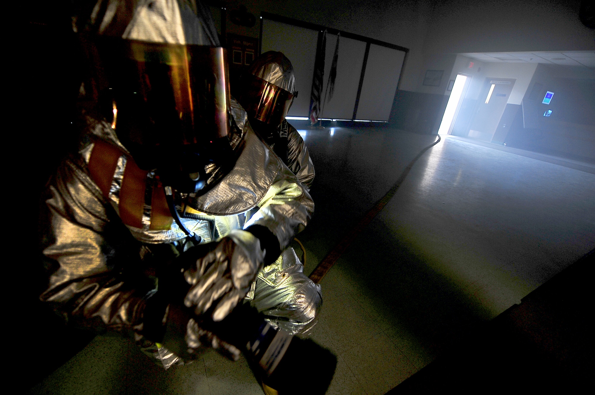 Fire fighters from the 51st Civil Engineer Squadron clear a building and extinguish simulated fires during a training scenario as part of an operational readiness exercise, Beverly Bulldog 13-02, at Osan Air Base, Republic of Korea, Feb. 12, 2013. These types of exercises help Airmen train in a heightened state of readiness in order to provide combat ready forces for close air support, air strike control, counter air, interdiction, theater airlift, and communications in the defense of the Republic of Korea. (U.S. Air Force photo/Staff Sgt. Sara Csurilla)