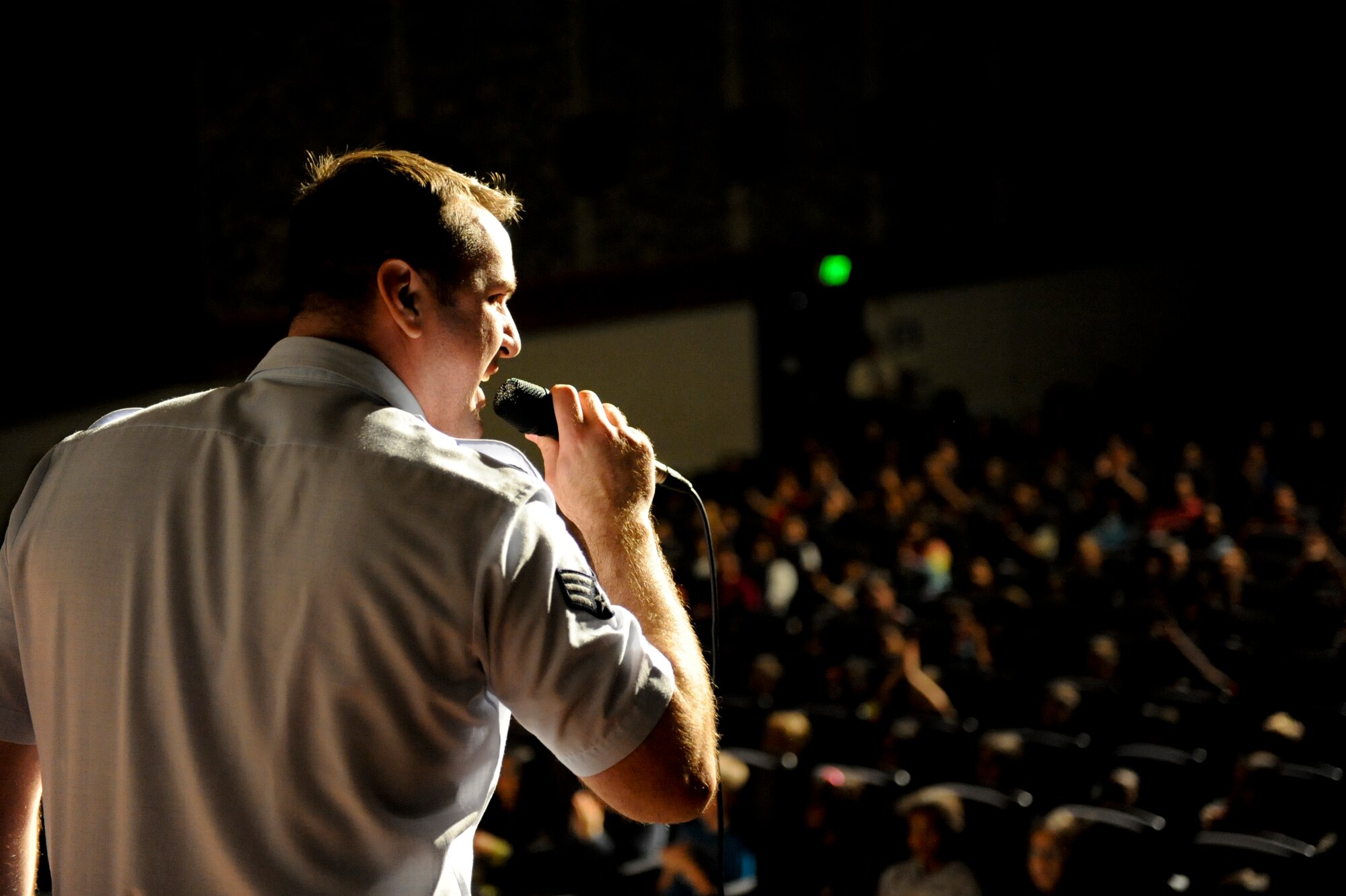 U.S. Air Force Senior Airman William Pressgrove, Pacific Air Forces band vocalist, sings a rock song during a performance at the Keystone Theater on Kadena Air Base, Japan, Feb. 7, 2013. The show was performed for more than 800 students from local military base schools. Later that evening the band performed again for all service members and their families. (U.S. Air Force photo/Airman 1st Class Brooke P. Doyle)