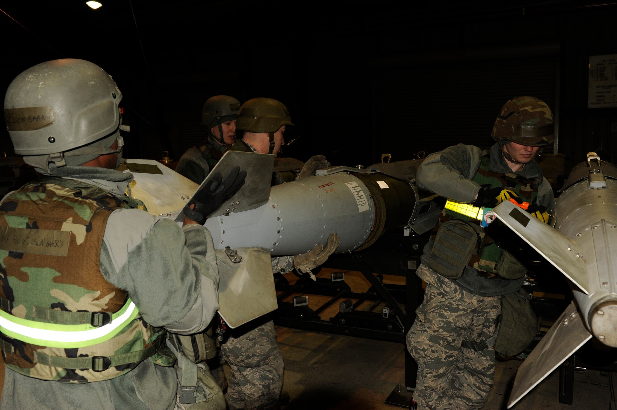 Members of the 8th Maintenance Squadron, assemble Joint Direct Attack Munitions during exercise Beverly Bulldog 13-2 at Kunsan Air Base, Republic of Korea, Feb. 12, 2013. The Airmen can assemble a JDAM in approximately three minutes. (U.S. Air Force photo by Senior Airman Marcus Morris/Released)