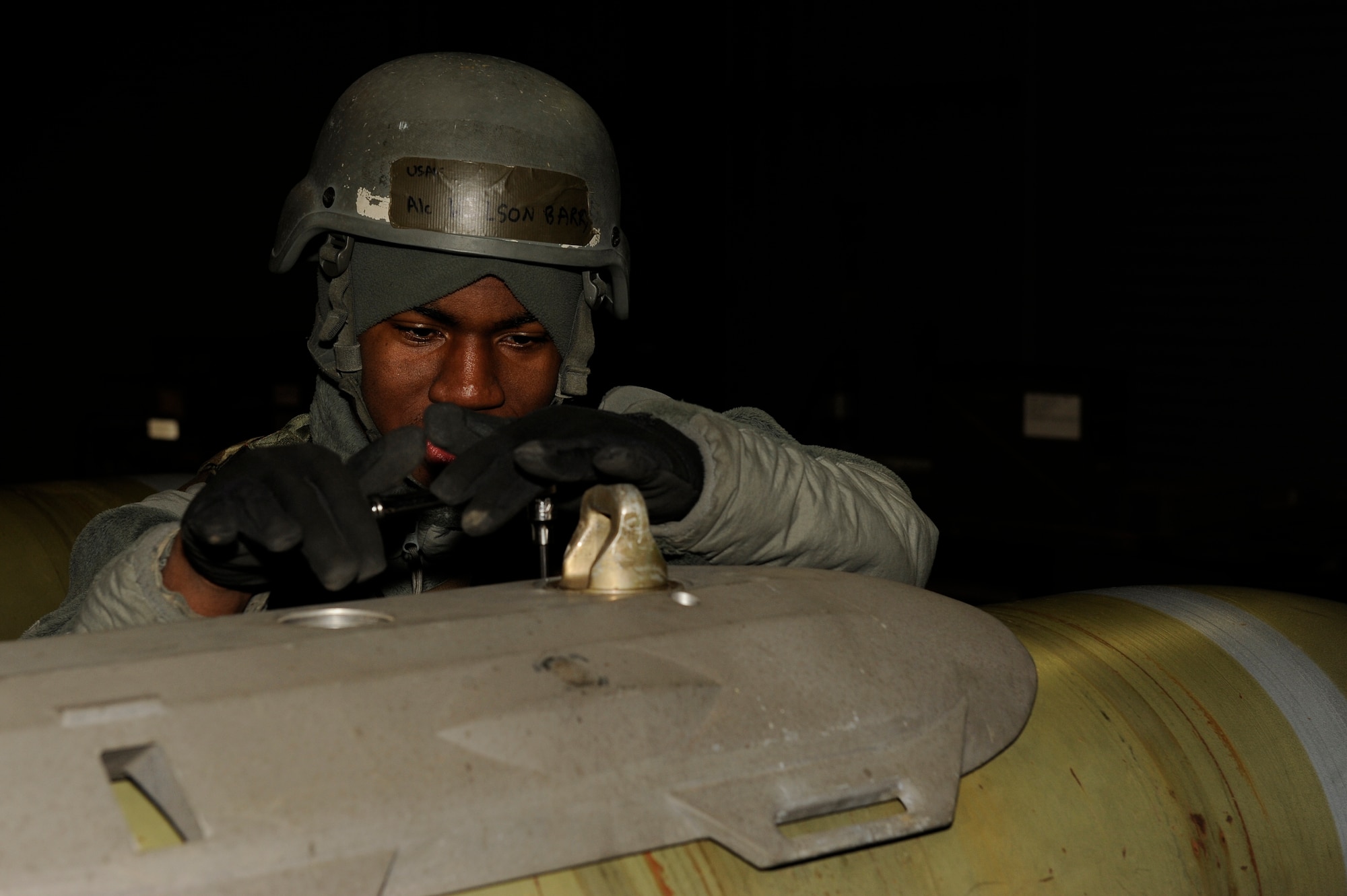 Airman 1st Class Barry Wilson, 8th Maintenance Squadron, attaches a panel to a Joint Direct Attack Munition during exercise Beverly Bulldog 13-2 at Kunsan Air Base, Republic of Korea, Feb. 12, 2013. The Airmen can assemble more than 80 JDAMs per 12- hour shift. (U.S. Air Force photo by Senior Airman Marcus Morris/Released)