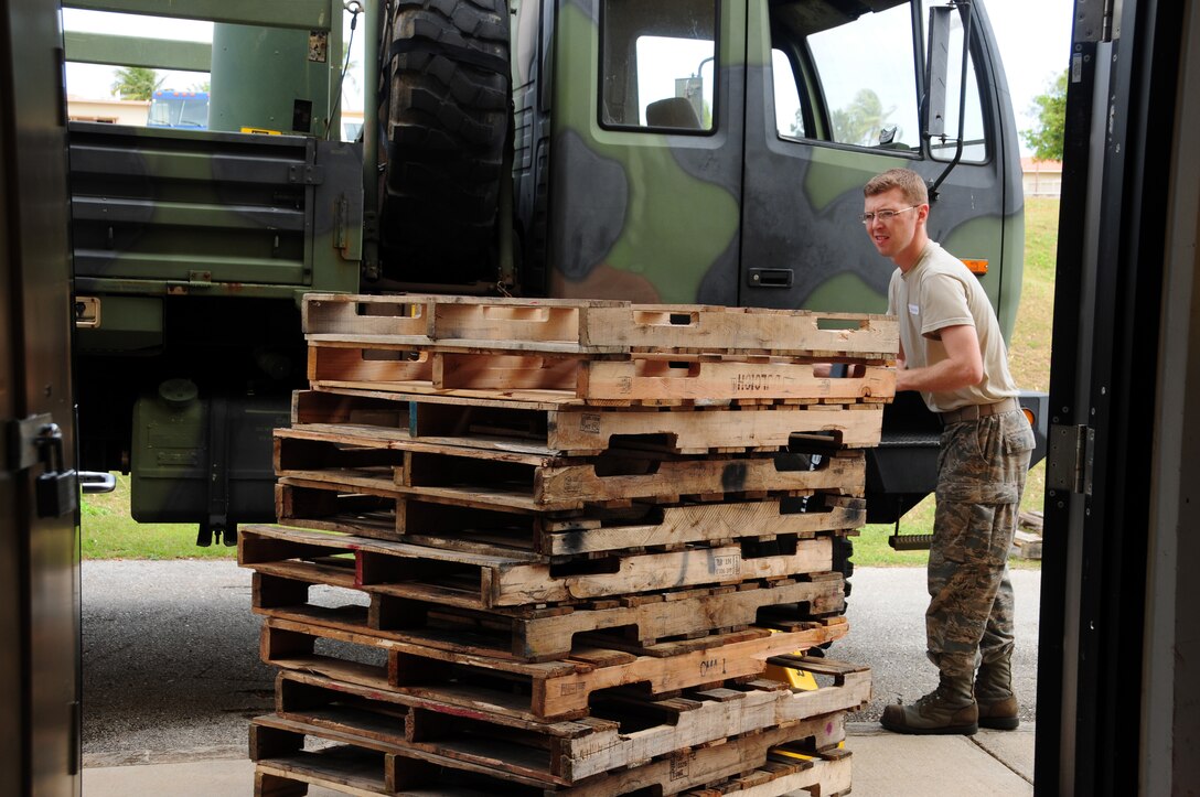 Staff Sgt. Clayton Riegle, 36th Operations Support Squadron flight equipment specialist, uses a manual pallet jack to push a stack of pallets during a volunteer event at Andersen Middle School here Feb. 7, 2013. Fifteen Airmen from Team Andersen volunteered to box and palletize more than 400 desks at AMS and send them to the Defense Reutilization and Marketing Office on Naval Base Guam. (U.S. Air Force photo by Senior Airman Robert Hicks/Released)