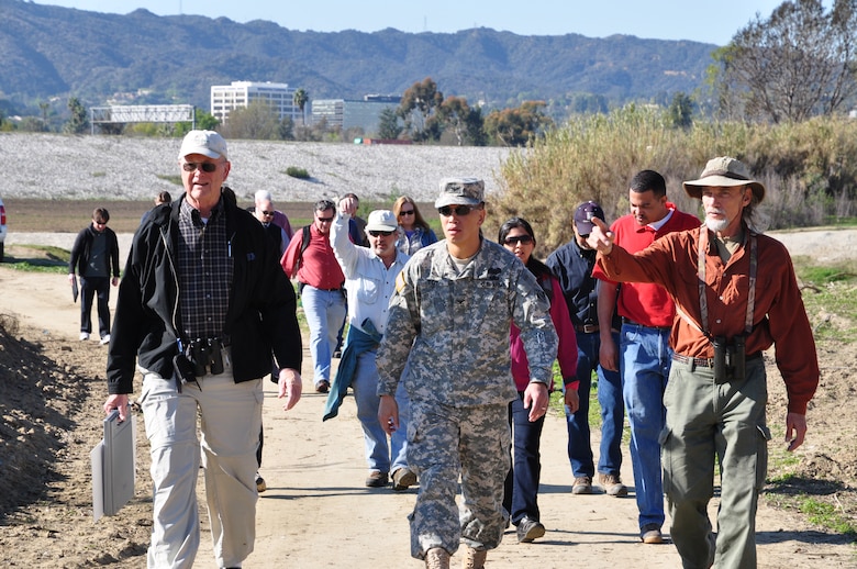 (Left to right) San Fernando Valley Audubon Society President Dave Weeshof, Los Angeles District Commander Col. Mark Toy and SFVAS Conservation Chair Kris Ohlenkamp lead a group of Corps employees and local environmentalists on a nature walk Feb. 12 at the Sepulveda Dam Basin vegetation management area. (USACE photo by Jay Field)
