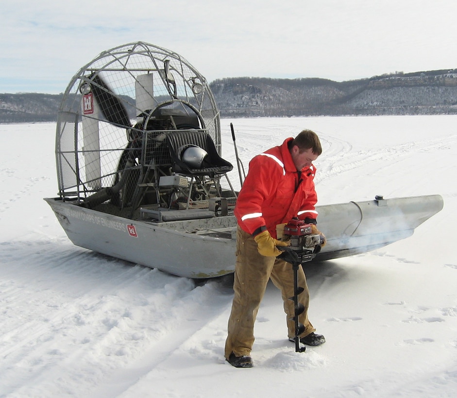 Brandon Olson, operations, drills one of the holes to measure the ice on Lake Pepin in 2011. The ice is measured every mile using global positioning system.