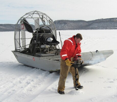 Brandon Olson, operations, drills one of the holes to measure the ice on Lake Pepin in 2011. The ice is measured every mile using global positioning system.