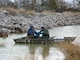 Men surveying by boat