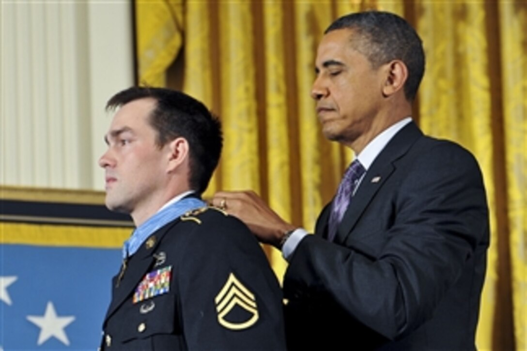 President Barack H. Obama awards the Medal of Honor to former Army Staff Sgt. Clinton L. Romesha during a ceremony at the White House in Washington, D.C., on Feb. 11, 2013.  Romesha received the Medal of Honor for his courageous actions during a daylong firefight in Afghanistan in October 2009.  
