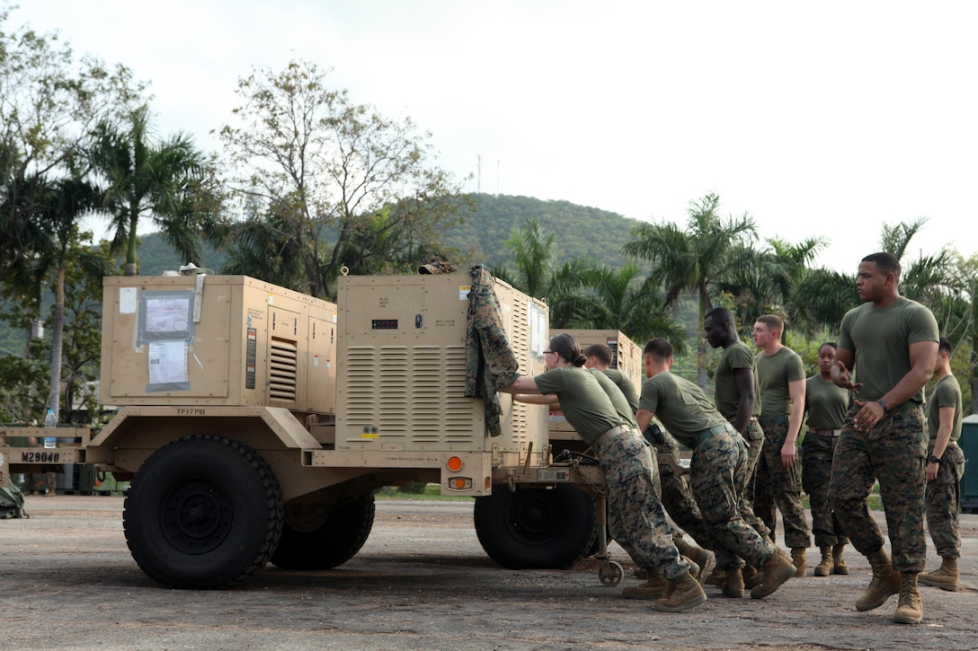 U.S. Marines from Combat Logistics Regiment 3 move equipment for their combat operations center Feb. 9 at Camp Samaesan in Sattahip, Kingdom of Thailand, which will facilitate communications between logistics units throughout the country during exercise Cobra Gold 2013. â€œWorking with the Thai Marines is quite an experience,â€ said U.S. Marine Lance Cpl. Andrew W. Berkowicz, a generator mechanic with CLR-3. â€œThere is a language barrier, but we share a special bond because we are both in the Marine Corps.â€ Cobra Gold, in its 32nd iteration, is a multinational exercise that promotes regional prosperity, security and cooperation among partner militaries. CLR- 3 is a part of 3rd Marine Logistics Group, III Marine Expeditionary Force.