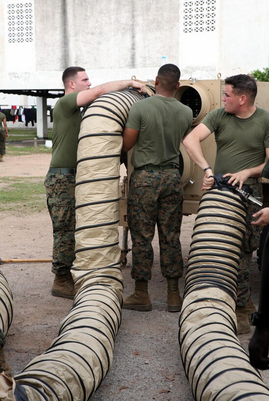 U.S. Marines from Combat Logistics Regiment 3 attach ventilation tubes to an air conditioner for their combat operations center Feb. 9 at Camp Samaesan in Sattahip, Kingdom of Thailand. The COC will facilitate communications between logistics units throughout the country during exercise Cobra Gold 2013. The exercise is a Thai-U.S. co-sponsored multinational, multiservice exercise that includes forces from Thailand, the U.S., Singapore, Japan, Republic of Korea, Indonesia, Malaysia, and observers from other countries in the region. CLR- 3 is a part of 3rd Marine Logistics Group, III Marine Expeditionary Force.
