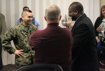 Lt. Col. Vincent J. Yasaki, commanding officer of the Center for Naval Aviation Technical Training speaks with representatives from Craven Community College  to sign an agreement to help CNATT Marines acquire degrees, Jan. 28. The participants in the program will receive up to four classes worth of credits for having done their military training.
