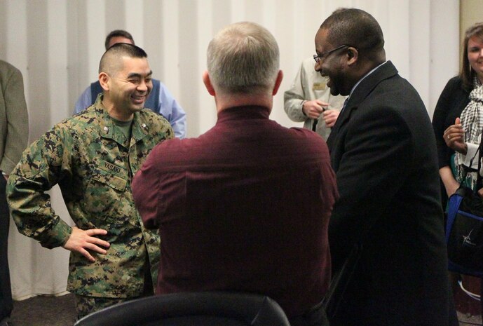 Lt. Col. Vincent J. Yasaki, commanding officer of the Center for Naval Aviation Technical Training speaks with representatives from Craven Community College  to sign an agreement to help CNATT Marines acquire degrees, Jan. 28. The participants in the program will receive up to four classes worth of credits for having done their military training.
