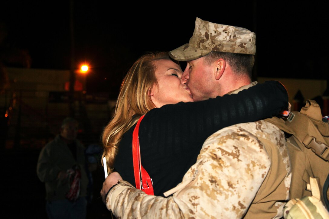 A Marine deployed with Combat Logistics Regiment 15, 1st Marine Logistics Group, kisses his wife during a homecoming aboard Camp Pendleton, Calif., Thursday, Feb. 7, 2013. Marines and sailors with CLR-15 were deployed to Helmand province, Afghanistan, in support of Regional Command Southwest. (U.S. Marine Corps photo by Cpl. Laura Gauna/Released)