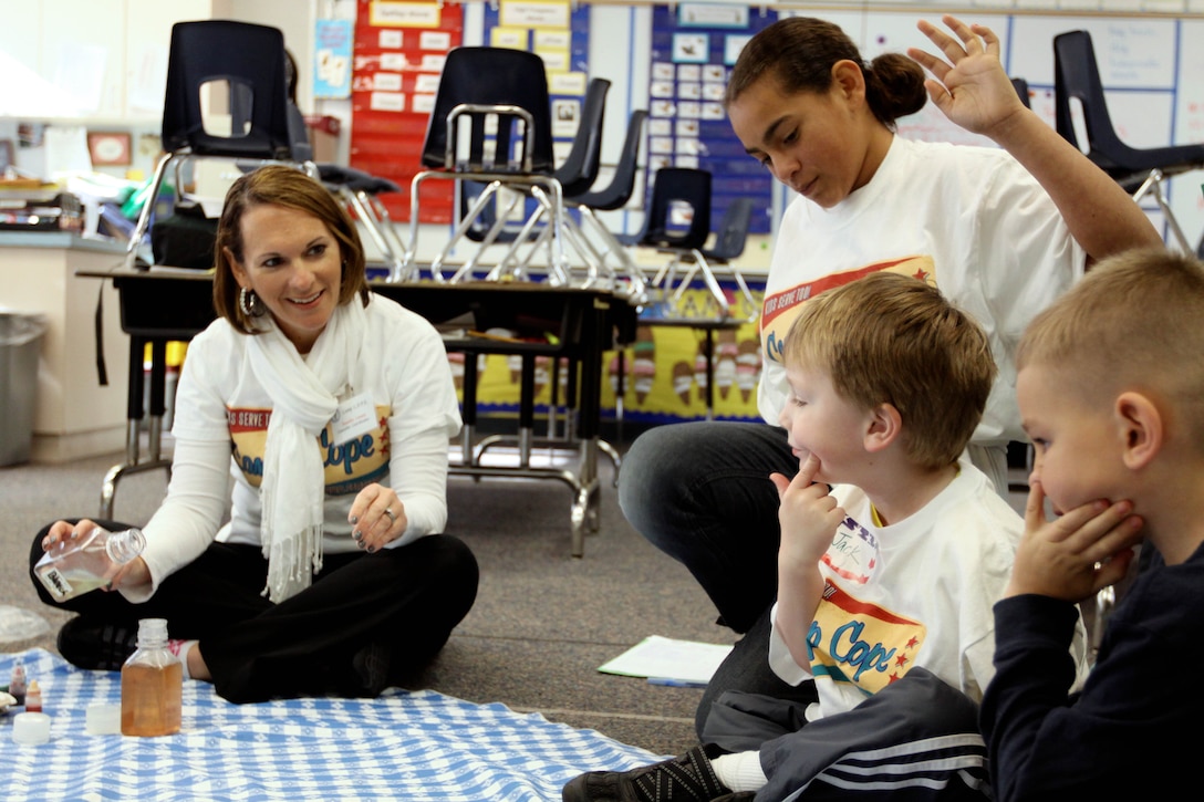 Jennifer Cowen, a volunteer for Camp C.O.P.E., listens to coping ideas from children during a group activity at the camp held at Stuart Mesa Elementary School here Feb. 9. The activity was focused on having the courage to accept the changes that may happen because of a parent's deployment or injury.
