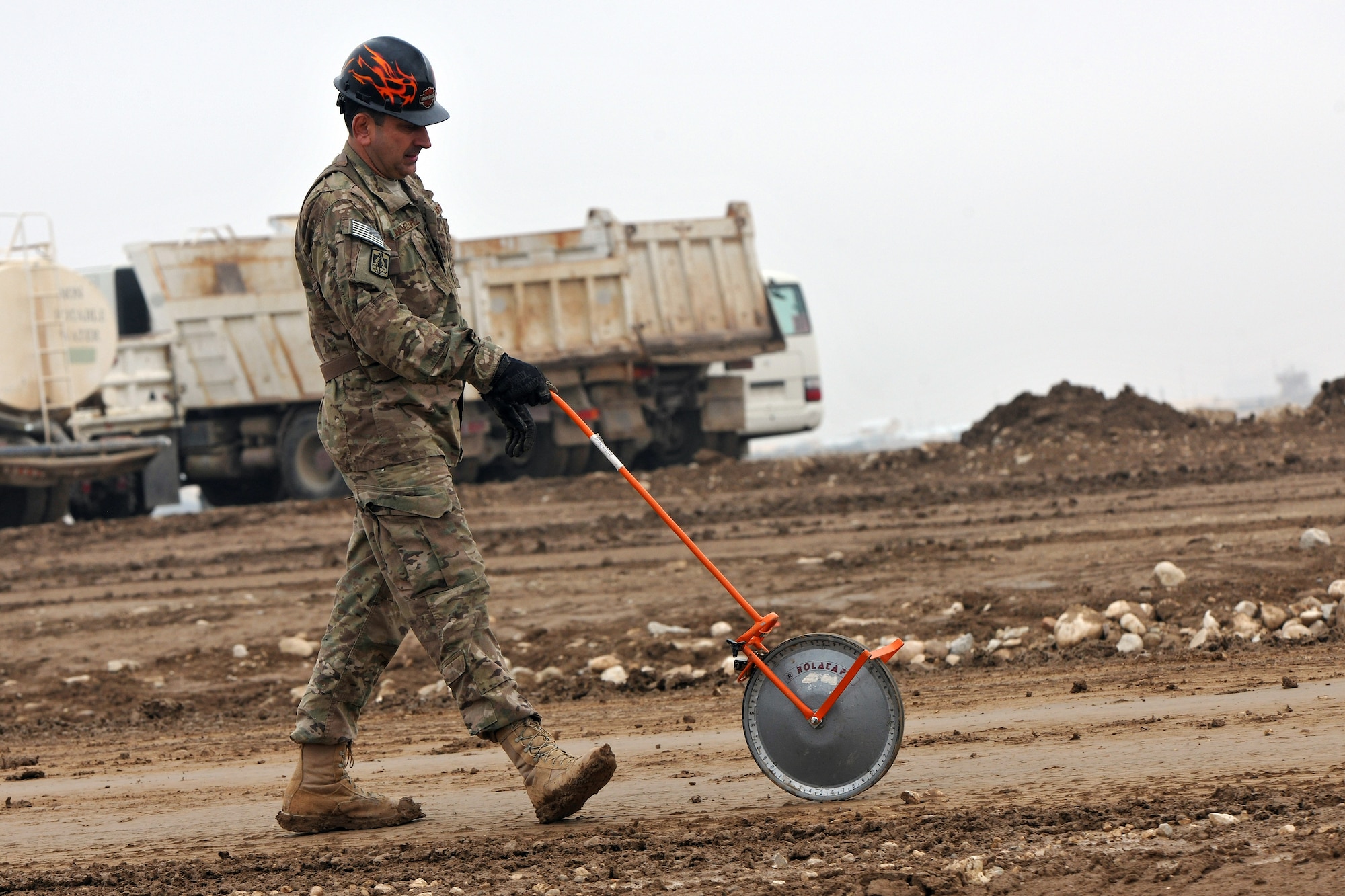 Maj. Ari Jimenez, 272nd Engineering and Installation Squadron officer in charge, utilizes an engineer measuring wheel to survey the land at Camp John Pratt, Afghanistan, Jan. 31, 2013.  The 272nd EIS are tasked with constructing the communications infrastructure used by thousands of servicemembers and military contractors at the camps located near the city of Mazar-e-Sharif. (U.S. Air Force photo/Senior Airman Chris Willis)
