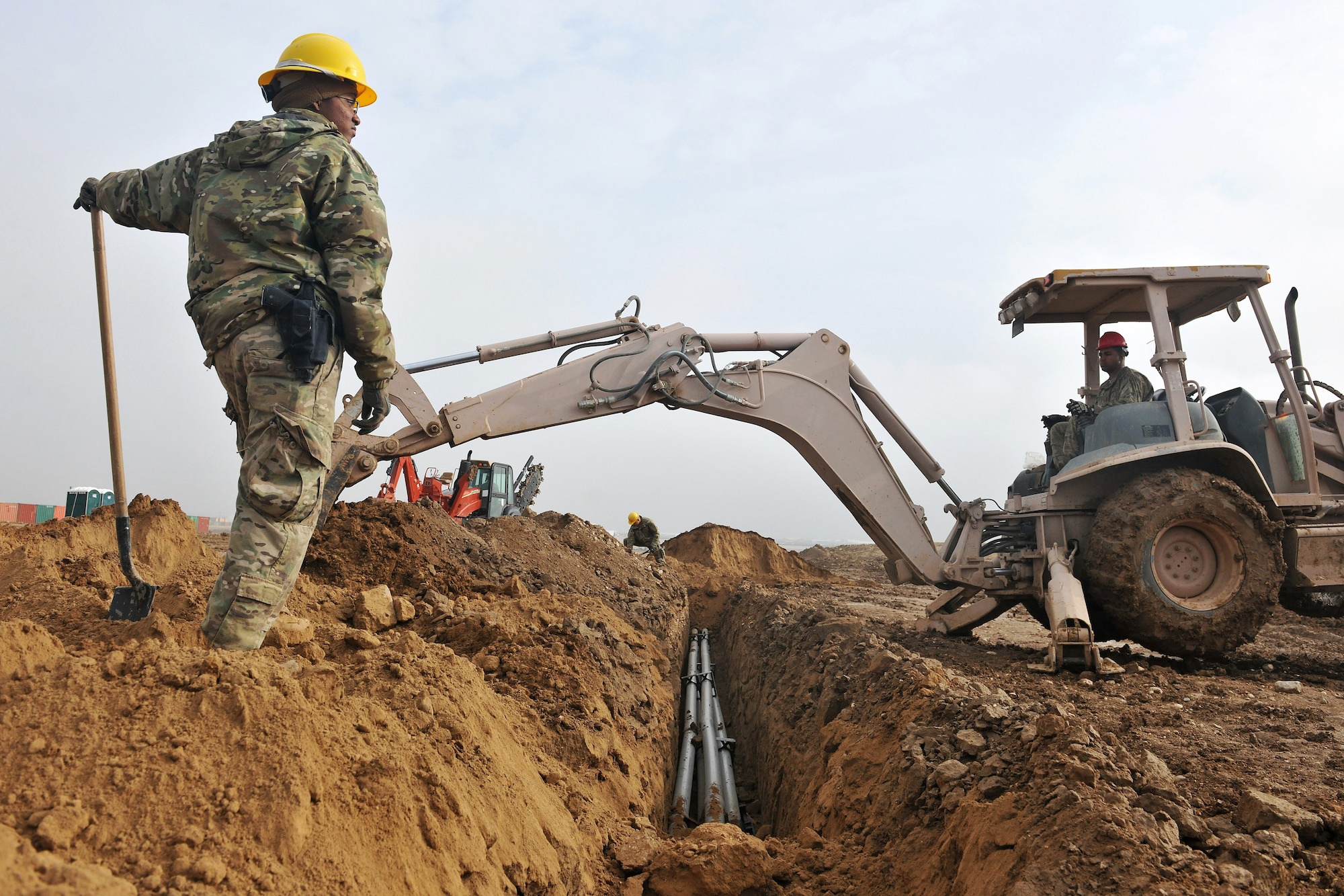 Senior Airman Shawna Fowler, 272nd Engineering and Installation Squadron journeyman, supervises a trench excavation at Camp John Pratt, Afghanistan, Jan. 31, 2013. Fowler, a Houston, Texas, native, is part of a team tasked to lay the entire fiber optic cable infrastructure connecting Camp Marmal to Camp John Pratt.  (U.S. Air Force photo/Senior Airman Chris Willis) 