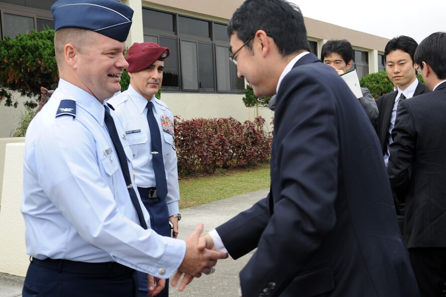 U.S. Air Force Col. Brian McDaniel, 18th Wing vice commander, shakes hands with DIET member Katsuyuki Kawai, Committee on Foreign Affairs chairman, at the 18th Wing headquarters building on Kadena Air Base, Japan, Feb. 11, 2013. Kawai visited the wing to understand Kadena's mission and tour the base. (U.S. Air Force photo/Naoto Anazawa)