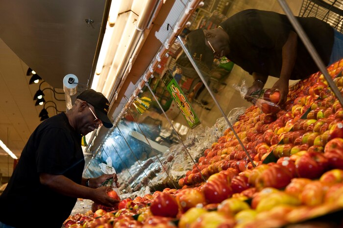 Retired U.S. Navy Chief Petty Officer Phillip Holsey, picks fresh apples from the Commissary Feb. 12, 2013, at Nellis Air Force Base, Nev. The Health and Wellness Center can help people achieve fitness and health goals by offering commissary tours. These tours provide knowledge about serving sizes, ingredients, calories and other nutrition-related topics. The tours are held on the second Wednesday of every month and last about 45 minutes. The next tour is March 13 at 2 p.m. (U.S. Air Force Photo by Senior Airman Daniel Hughes) 