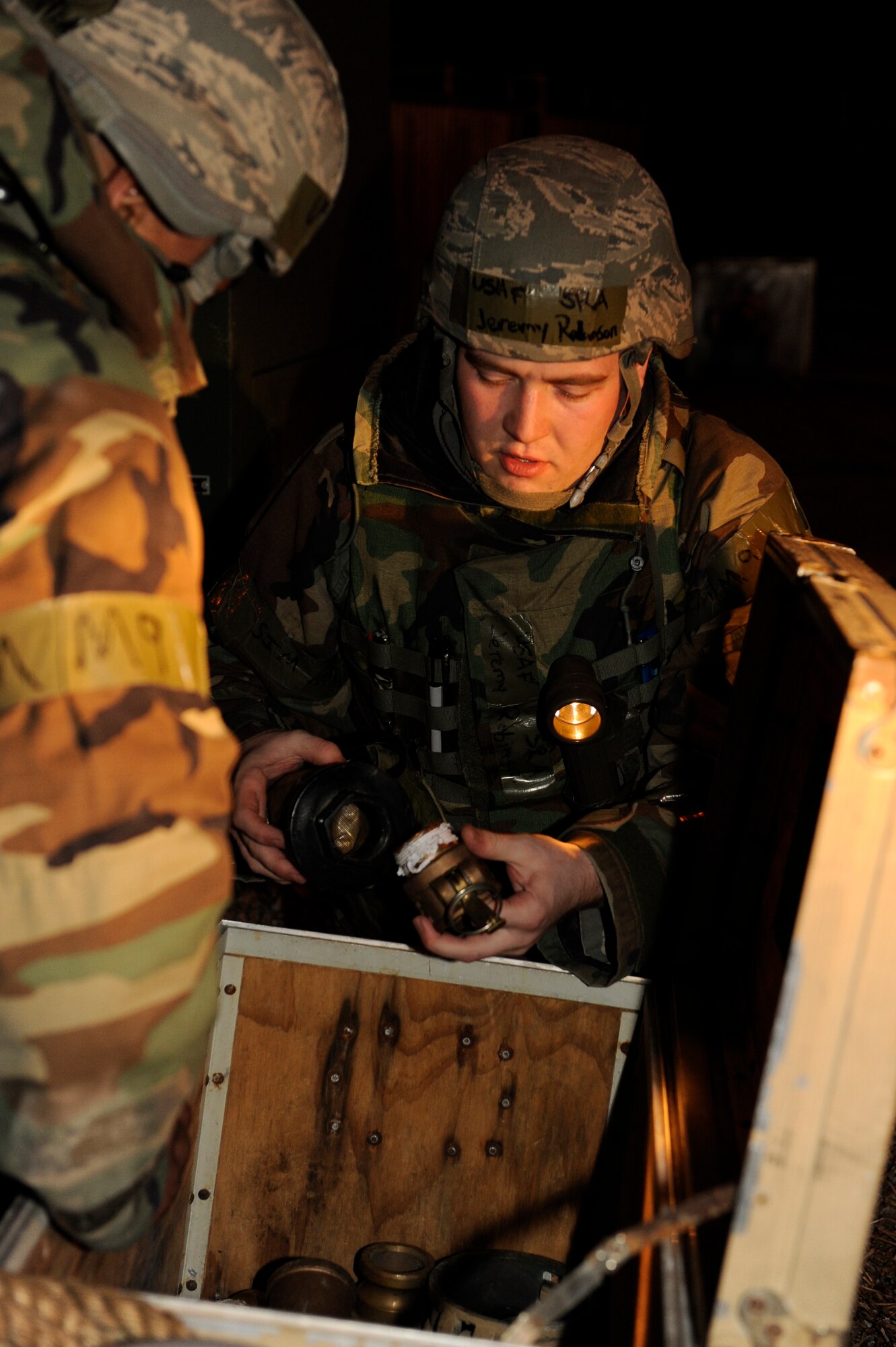 Senior Airman Jeremy Robinson, right, 8th Civil Engineer Squadron, grabs attachments for water hoses as Senior Airman Marvin Carter, 8th CES, assists him during exercise Beverly Bulldog 13-2 at Kunsan Air Base, Republic of Korea, Feb. 13, 2013. The Airmen were turning on a reverse-osmosis, water-purification system to supply safe drinking water to the base. (U.S. Air Force photo by Senior Airman Marcus Morris/Released)