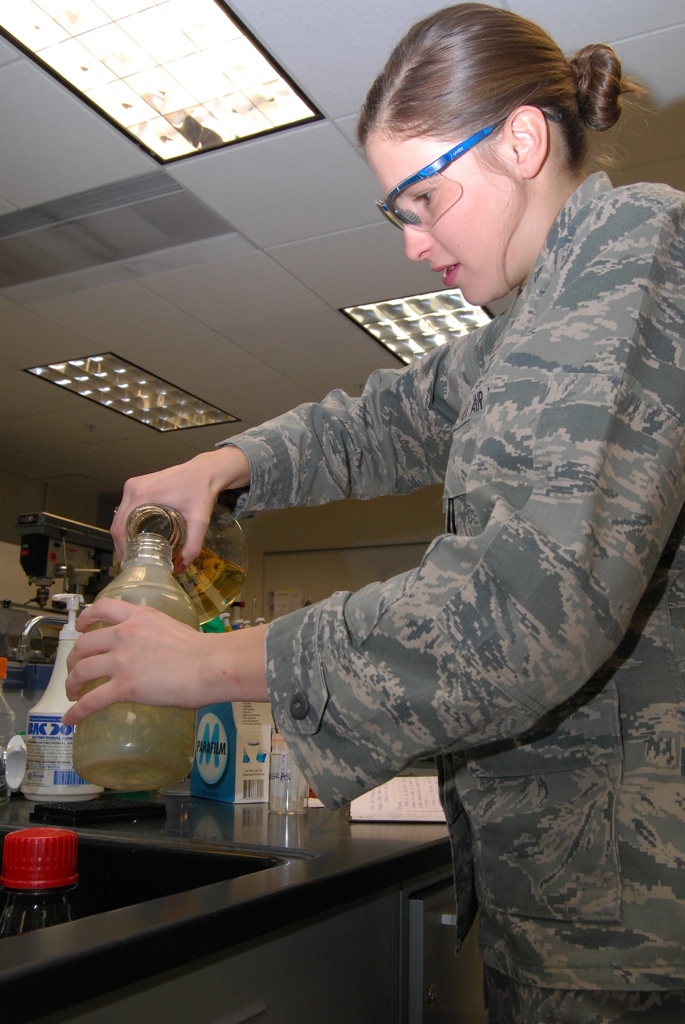 Cadet 1st Class Alexa Gingras prepares a lysogeny broth during her biochemistry lab Feb. 13, 2013. The broth is used to grow bacteria, which Gingras uses to produce fluorescent proteins for her research, which involves getting fluorescent proteins to react to illegal drugs. Gingras is a native of Tucson, Ariz. (U.S. Air Force photo/Don Branum)