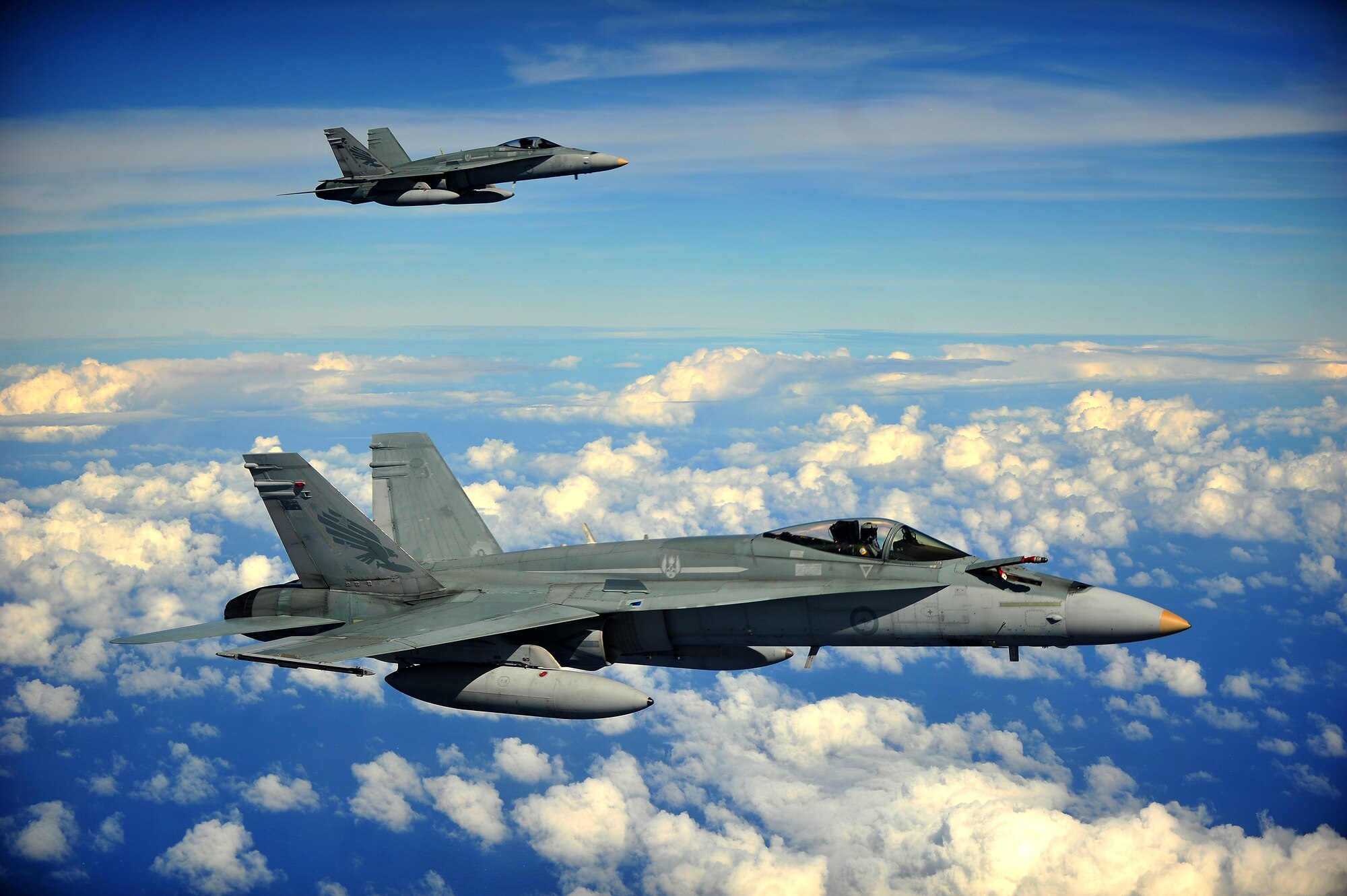 Two Royal Australian Air Force F/A-18 Hornets form up in preparation to conduct an air refuel while participating in Cope North 13 near Anderson Air Force Base, Guam, Feb. 13, 2013. The F/A-18 Hornet is a multi-role fighter designed for both air-to-air and air-to-ground missions. Cope North is an annual air combat tactics, humanitarian assistance and disaster relief exercise designed to increase the readiness and interoperability of the U.S. Air Force, Japan Air Self-Defense Force and Royal Australian Air Force.. (U.S. Air Force photo by Senior Airman Matthew Bruch/Released)
