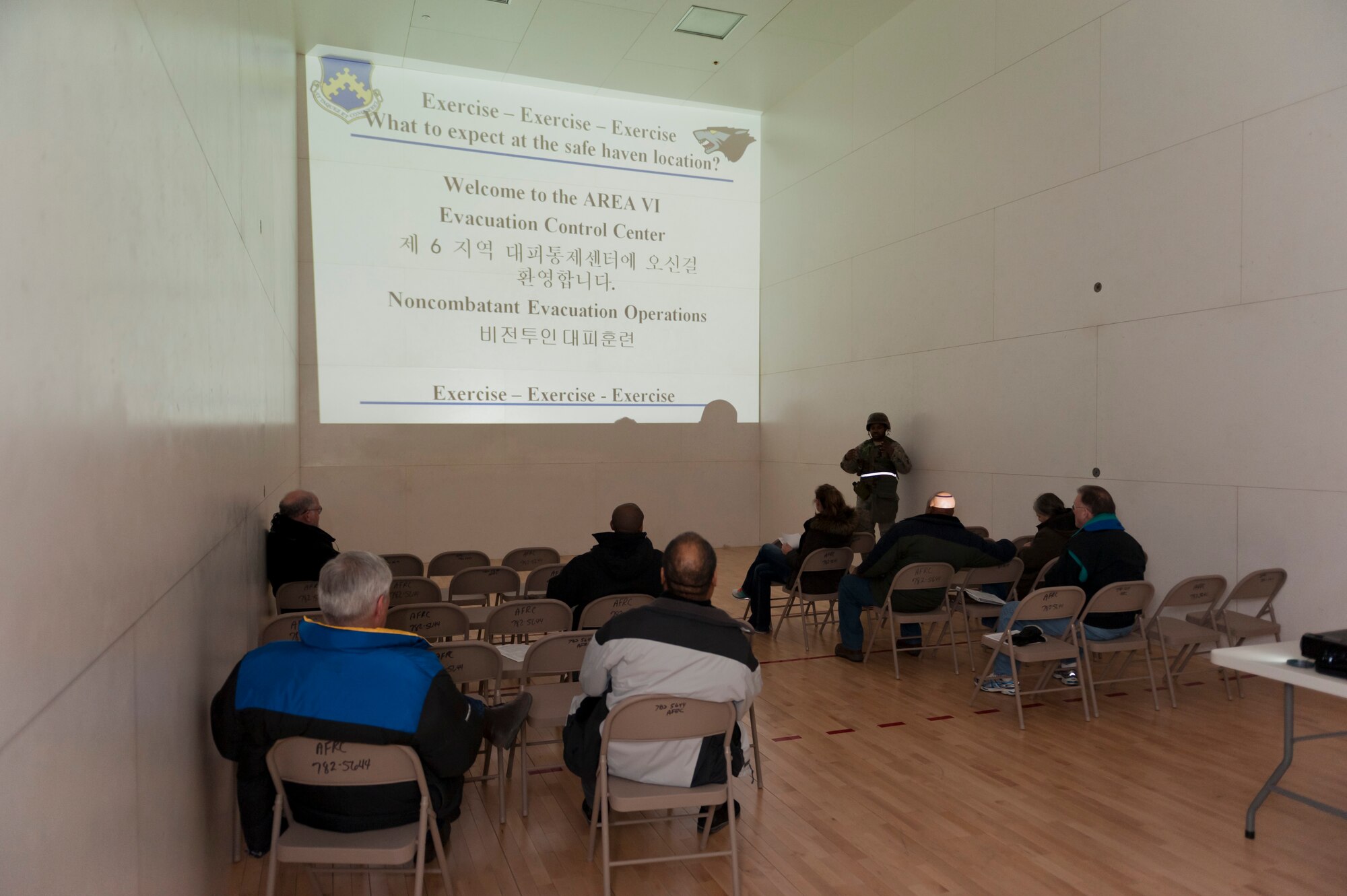 KUNSAN AIR BASE, Republic of Korea -- Staff Sgt. Joseph Smith, 8th Fighter Wing Communications Squadron briefs members of the Noncombatant Evacuation Operation (NEO) during exercise Beverly Bulldog 13-2 at Kunsan Air Base, Republic of Korea Feb. 12, 2013. The NEO rehearses the process civilians must go through if they have to evacuate the base in a war time contingency.  (U.S. Air Force photo by Tech. Sgt. Michael Schocker)