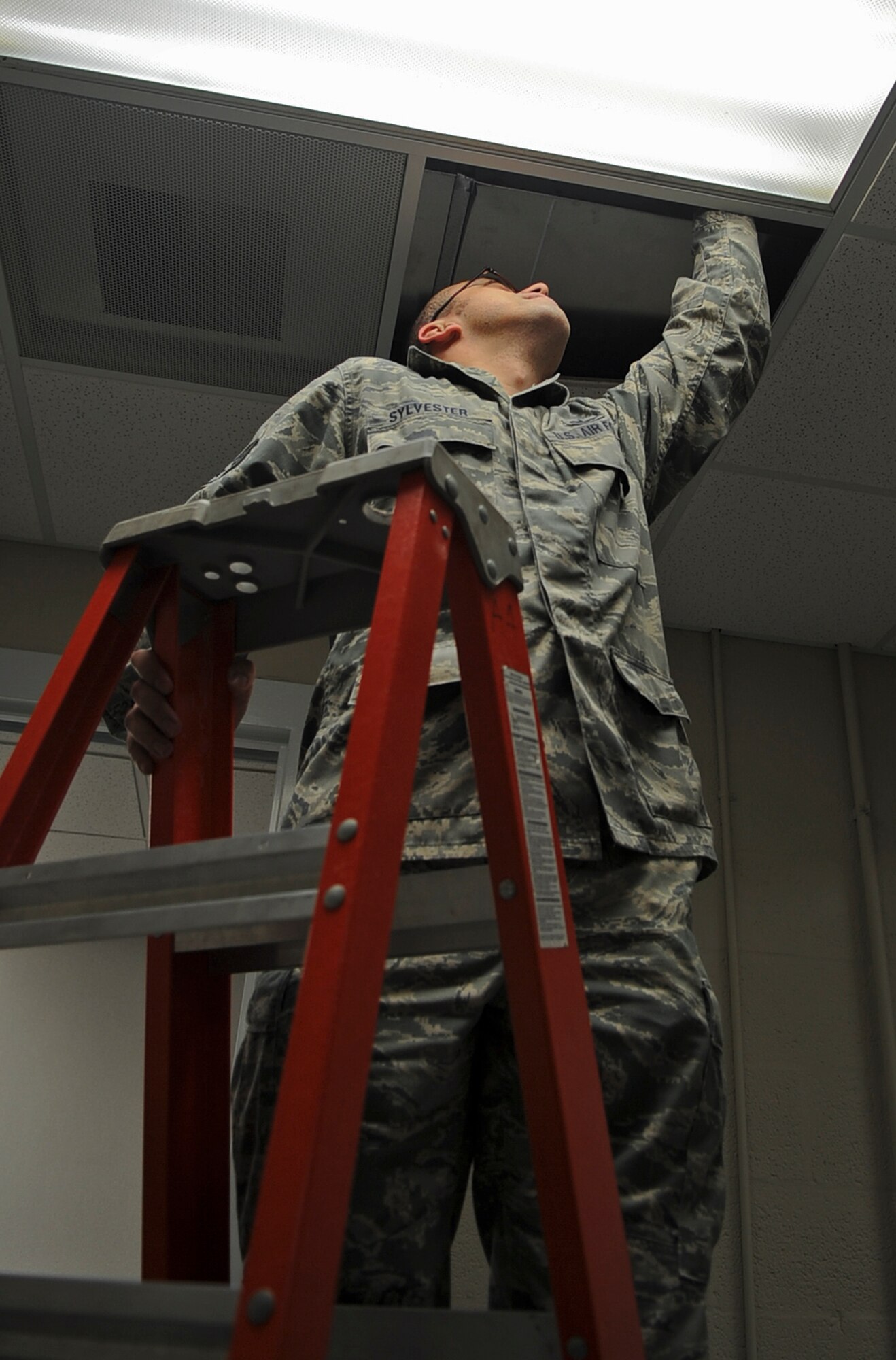 Staff Sgt. Thomas Sylvester, 8th Air Force NCO in-charge Civil Engineering, checks a heating, ventilation, air conditioning and refrigeration duct on Barksdale Air Force Base, La., Feb. 11. The HVAC systems delivers hot and cold air to each office to ensure that computer systems and electronics can operate without failing. (U.S. Air Force photo/Staff Sgt. Jason McCasland)