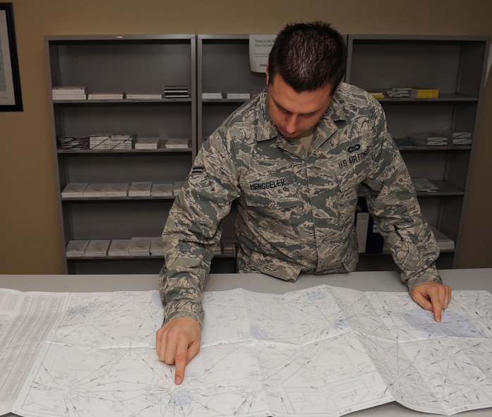 Airman 1st Class Andrew Henggeler, 2nd Operations Support Squadron airfield management, reviews a flight map on Barksdale Air Force Base, La., Feb. 13. Flight maps details the routes military and commercial aircraft must follow when flying. Airfield management ensures the integrity of the airfield by checking the pavement for cracks and damage, foreign object debris and wildlife. (U.S. Air Force photo/Airman 1st Class Benjamin Gonsier)