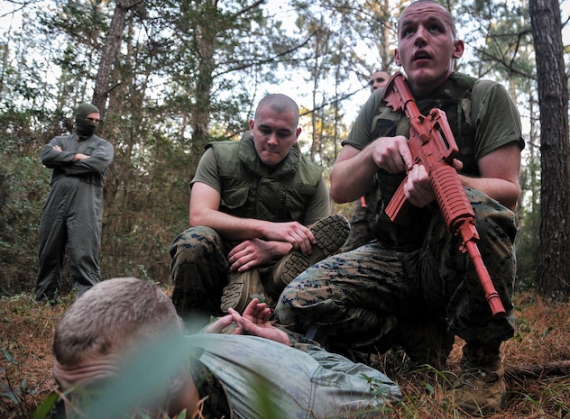 U.S. Marine Corps Cpl. Roger Ramsey and Lance Cpl. Brandon Everhart, Naval Consolidated Brig Charleston corrections specialist, detain a fellow Marine during Marine Corps Martial Arts Program training Feb. 7, 2013, at Joint Base Charleston – Weapons Station, S.C. MCMAP is a hand-to-hand, close quarter combat and weapons training program designed to educate, improve technique and boost morale throughout the Corps. Marines stationed at the NCBC participate in MCMAP four times a week. (U. S. Air Force photo/Airman 1st Class Jared Trimarchi) 
