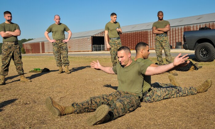 U.S. Marine Corps Sgt. Cody Prickett (left) and Cpl. Osvaldo Roa, Naval Consolidated Brig Charleston corrections specialists, are in the grapple starting position during a Marine Corps Martial Arts Program training Feb. 7, 2013, at Joint Base Charleston – Weapons Station, S.C. MCMAP is a hand-to-hand, close quarter combat and weapons training program designed to educate, improve technique and boost morale throughout the Corps. Marines stationed at the NCBC participate in MCMAP four times a week. (U. S. Air Force photo/Airman 1st Class Jared Trimarchi) 