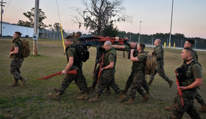 Naval Consolidated Brig Charleston corrections specialist Marines transport a wounded Marine during Marine Corps Martial Arts Program training Feb. 7, 2013, at Joint Base Charleston – Weapons Station, S.C. MCMAP is a hand-to-hand, close quarter combat and weapons training program designed to educate, improve technique and boost morale throughout the Corps. Marines stationed at the NCBC participate in MCMAP four times a week. (U. S. Air Force photo/Airman 1st Class Jared Trimarchi) 