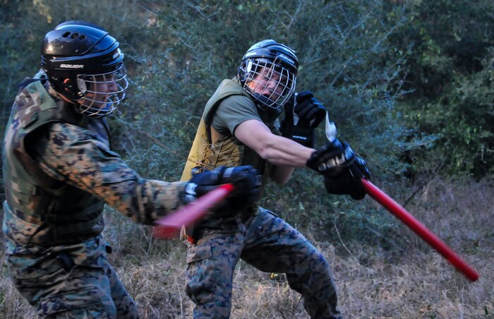 U.S. Marine Corps Sgt. Sean O’Donnell (left) and Lance Cpl. Christian Spotanski, Naval Consolidated Brig Charleston corrections specialists, swing training batons during Marine Corps Martial Arts Program training Feb. 7, 2013, at Joint Base Charleston – Weapons Station, S.C. MCMAP is a hand-to-hand, close quarter combat and weapons training program designed to educate, improve technique and boost morale throughout the Corps. Marines stationed at the NCBC participate in MCMAP four times a week. (U. S. Air Force photo/Airman 1st Class Jared Trimarchi) 