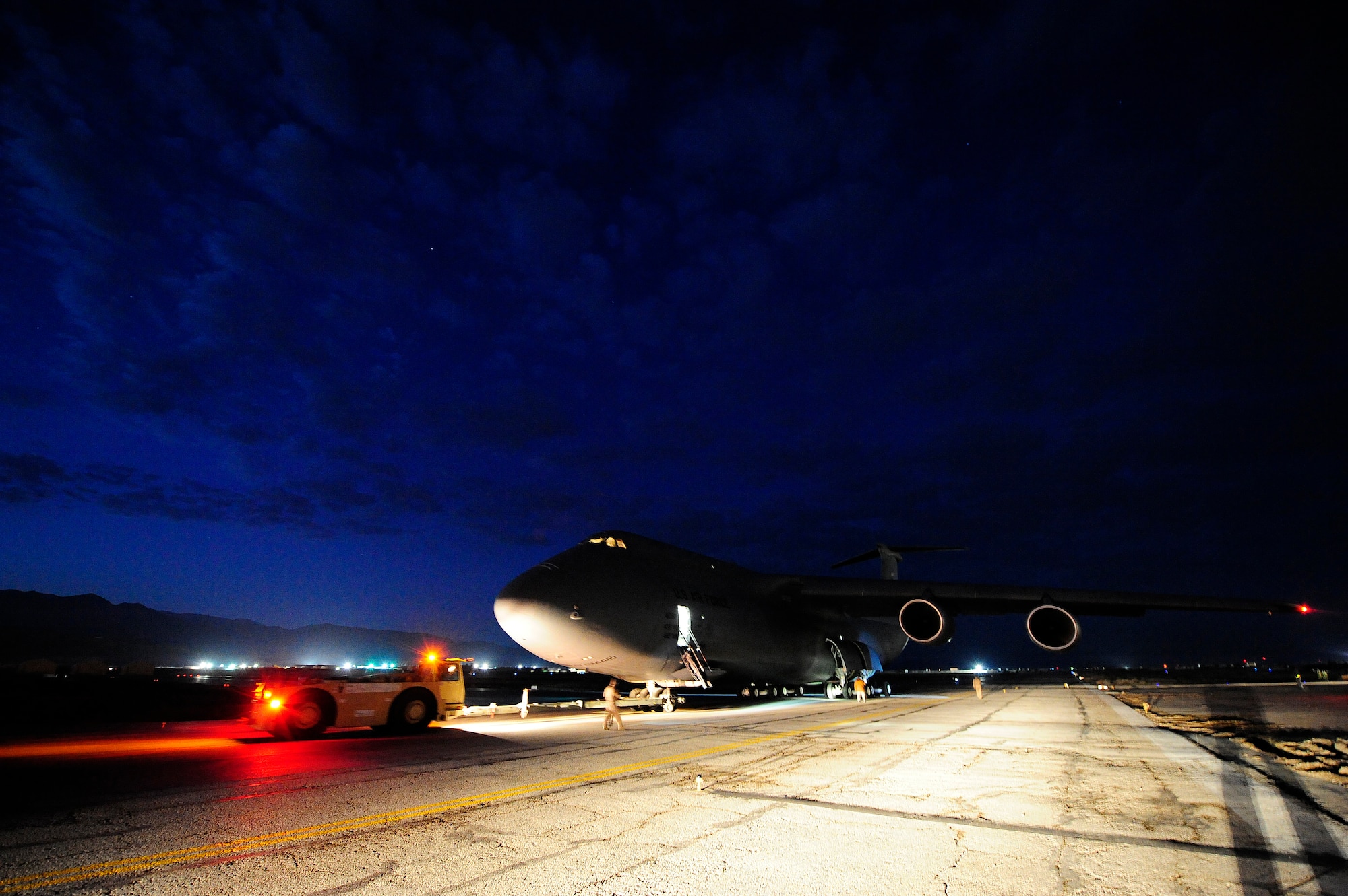 U.S. airmen prepare to push a C-5M Super Galaxy aircraft assigned to the 436th Airlift Wing (AW) at Dover Air Force Base, Del., into position for refueling Jan. 26, 2013, at Camp Marmal, Afghanistan. The 436th AW conducted the first C-5M multimodal deployment operation in support of U.S. Transportation Command. (U.S. Air Force photo by Tech Sgt. Parker Gyokeres/Released)