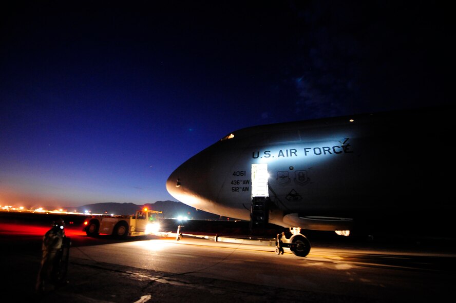 U.S. airmen push a C-5M Super Galaxy aircraft assigned to the 436th Airlift Wing (AW) at Dover Air Force Base, Del., into position for refueling Jan. 26, 2013, at Camp Marmal, Afghanistan. The 436th AW conducted the first C-5M multimodal deployment operation in support of U.S. Transportation Command. (U.S. Air Force photo by Tech Sgt. Parker Gyokeres/Released)