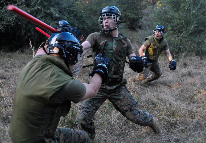 U.S. Marine Corps Pfc. Trae Neumann, a Naval Consolidated Brig Charleston corrections specialist, hits a fellow Marine with a training baton during a Marine Corps Martial Arts Program training Feb. 7, 2013, at Joint Base Charleston – Weapons Station, S.C. MCMAP is a hand-to-hand, close quarter combat and weapons training program designed to educate, improve technique and boost morale throughout the Corps. Marines stationed at the NCBC participate in MCMAP four times a week. (U. S. Air Force photo/Airman 1st Class Jared Trimarchi) 