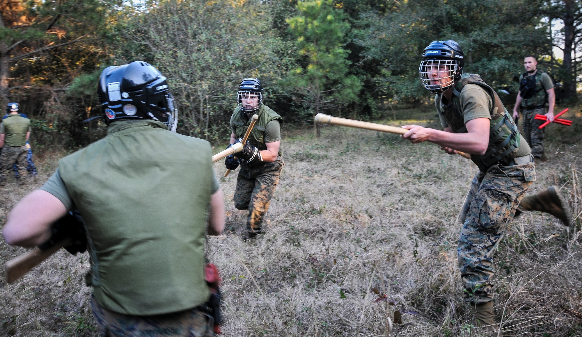 U.S. Marine Corps Lance Cpl. Zackery Vance (right) and Lance Cpl. Robert Ireland, Naval Consolidated Brig Charleston corrections specialists, attack a fellow Marine during Marine Corps Martial Arts Program training Feb. 7, 2013, at Joint Base Charleston – Weapons Station, S.C. MCMAP is a hand-to-hand, close quarter combat and weapons training program designed to educate, improve technique and boost morale throughout the Corps. Marines stationed at the NCBC participate in MCMAP four times a week. (U. S. Air Force photo/Airman 1st Class Jared Trimarchi) 