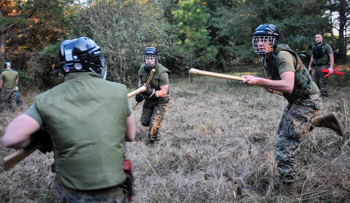 U.S. Marine Corps Lance Cpl. Zackery Vance (right) and Lance Cpl. Robert Ireland, Naval Consolidated Brig Charleston corrections specialists, attack a fellow Marine during Marine Corps Martial Arts Program training Feb. 7, 2013, at Joint Base Charleston – Weapons Station, S.C. MCMAP is a hand-to-hand, close quarter combat and weapons training program designed to educate, improve technique and boost morale throughout the Corps. Marines stationed at the NCBC participate in MCMAP four times a week. (U. S. Air Force photo/Airman 1st Class Jared Trimarchi) 