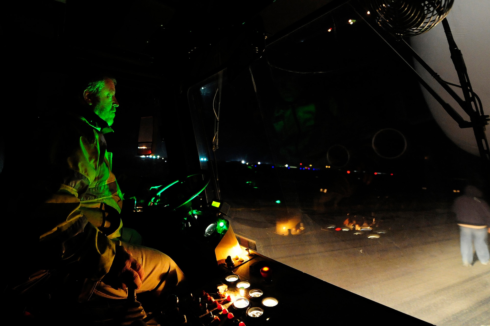 Earnest Midgett, a civilian transient alert mechanic, uses a large aircraft tug to position a C-5M Super Galaxy aircraft assigned to the 436th Airlift Wing at Dover Air Force Base, Del., for refueling Jan. 26, 2013, at Camp Marmal, Afghanistan. The 436th AW conducted the first C-5M multimodal deployment operation in support of U.S. Transportation Command. (U.S. Air Force photo by Tech Sgt. Parker Gyokeres/Released)