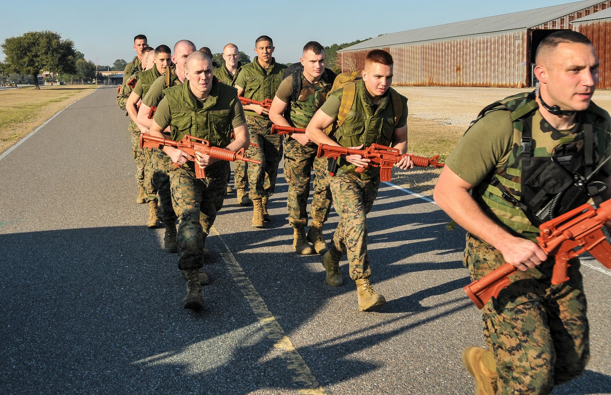 Naval Consolidated Brig Charleston corrections specialists Marines begin a foot patrol during Marine Corps Martial Arts Program training Feb. 7, 2013, at Joint Base Charleston – Weapons Station, S.C. MCMAP is a hand-to-hand, close quarter combat and weapons training program designed to educate, improve technique and boost morale throughout the Corps. Marines stationed at the NCBC participate in MCMAP four times a week. (U. S. Air Force photo/Airman 1st Class Jared Trimarchi) 