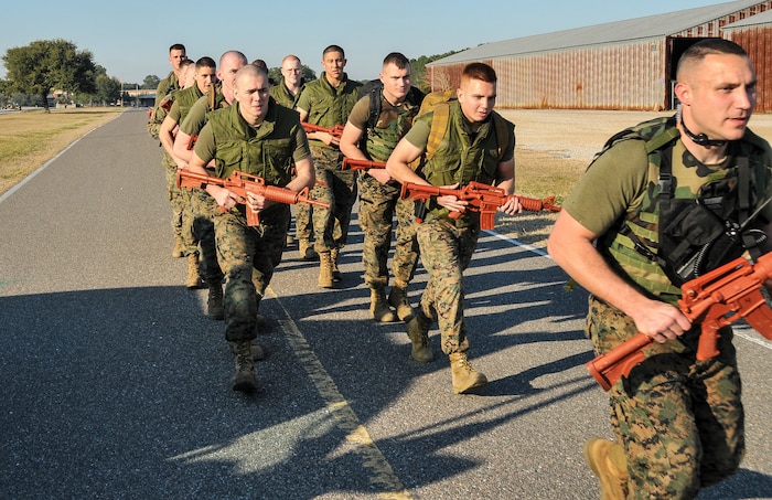 Naval Consolidated Brig Charleston corrections specialists Marines begin a foot patrol during Marine Corps Martial Arts Program training Feb. 7, 2013, at Joint Base Charleston – Weapons Station, S.C. MCMAP is a hand-to-hand, close quarter combat and weapons training program designed to educate, improve technique and boost morale throughout the Corps. Marines stationed at the NCBC participate in MCMAP four times a week. (U. S. Air Force photo/Airman 1st Class Jared Trimarchi) 
